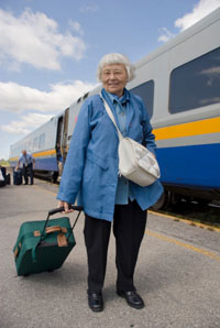 Elderly woman at passenger train platform