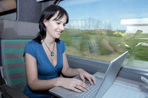 woman on train with laptop